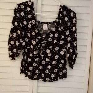 Fun floral blouse with tie in the front.